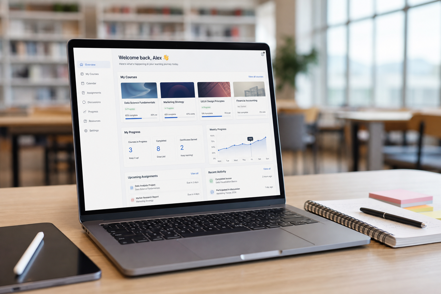 Laptop showing a learning management dashboard with courses and progress charts
